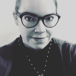 woman with glasses smiling