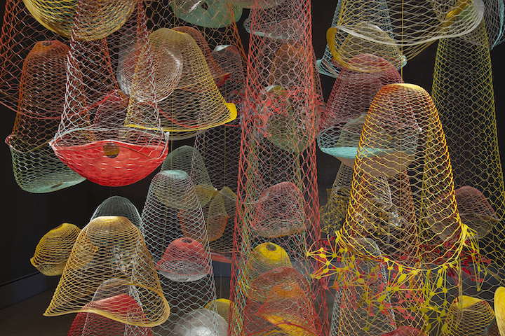 Red, yellow, green, teal blobs that look like hanging netting
