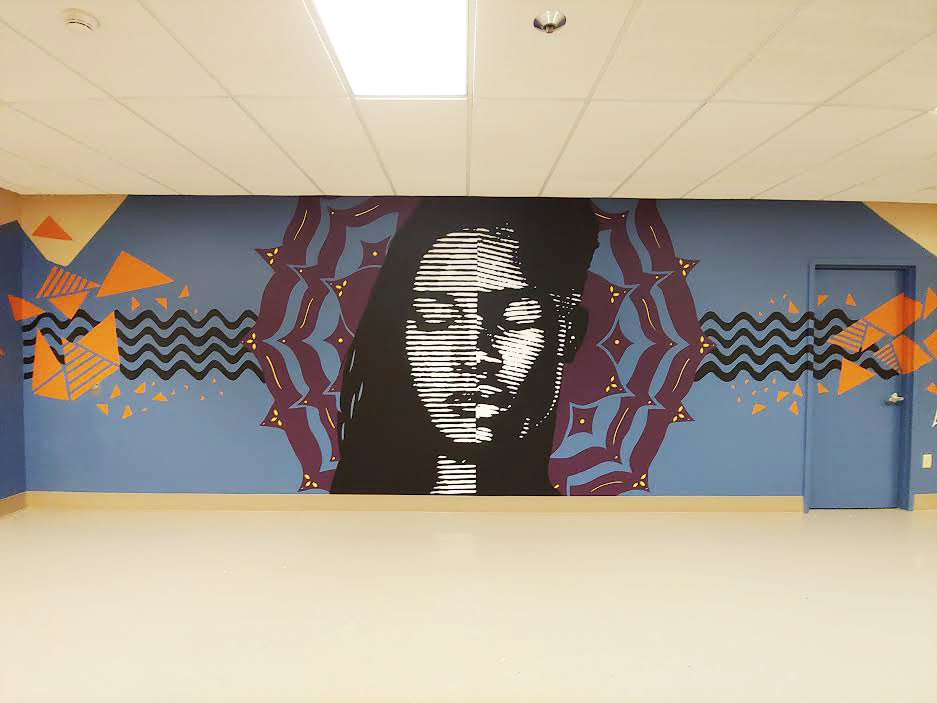 Image of finished mural showing a face with eyes closed over a blue background