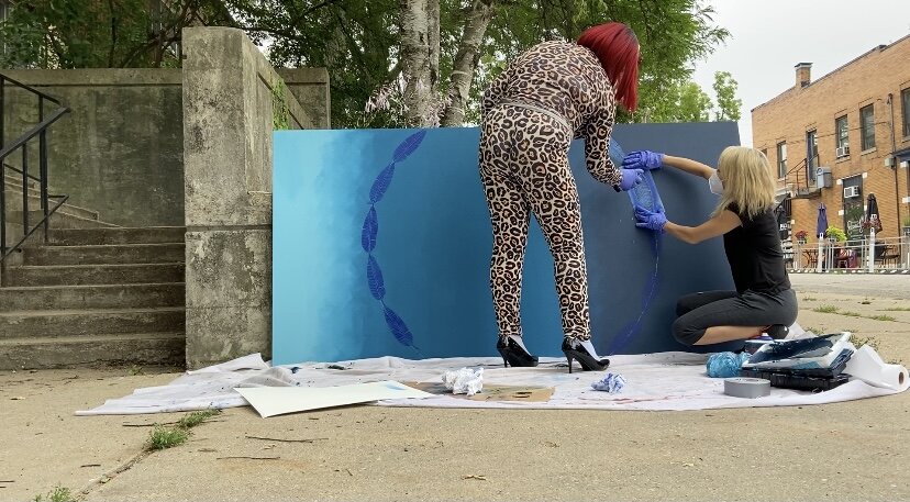 Teens working on mural outside
