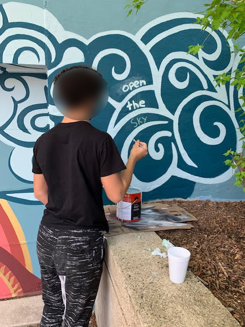 Teen coloring dark and light blue mural