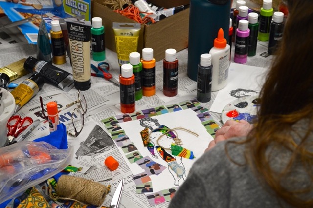 Student creating body mapping image referencing migration to the United States.