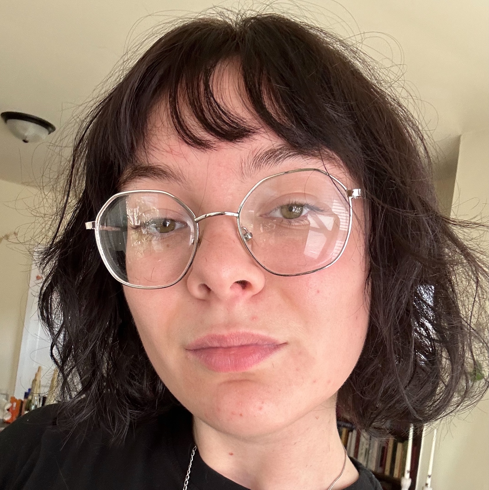 Image of Carlee Kessler. Carlee is wearing glasses and a black shirt.