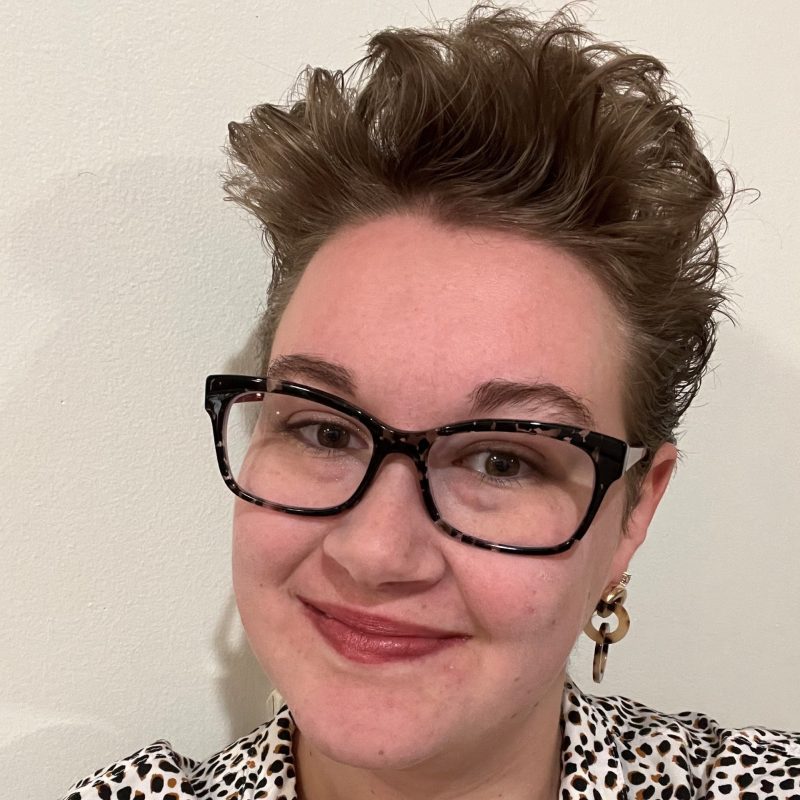 Image of Helen Rottier. Helen is wearing glasses and a leopard print shirt and appears in front of a white background.