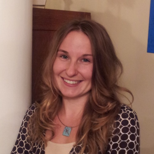 Image of Stephanie Rytilahti. Stephanie is wearing a teal necklace, has long blond hair, and a brown shirt.